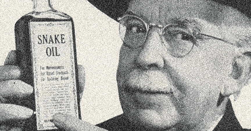 A black and white photo of an older man with glasses and mustache, looking at the camera and holding up and pointing to a bottle of Snake Oil.