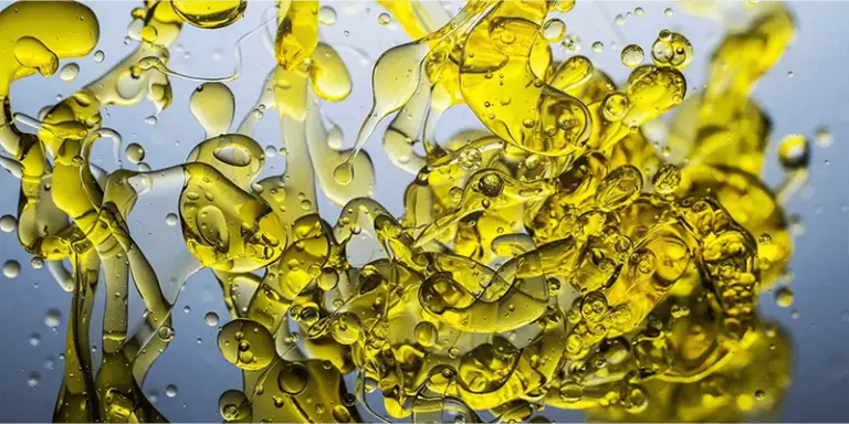 Bubbles of oil floating around in water, highlighting the various oils that are included in Murphy's Oil Soap including citronella.