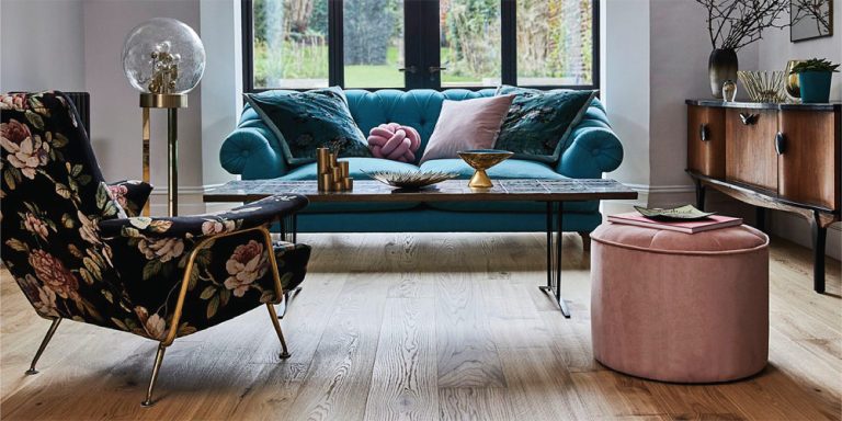 Well appointed living room with wood floors and window looking out to back yard