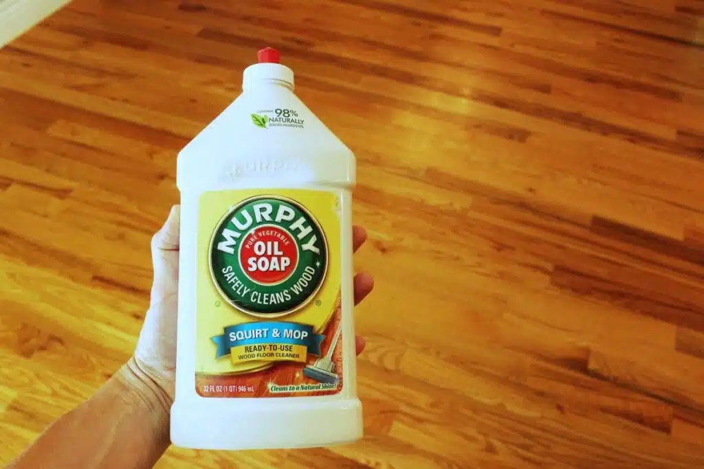 Man holding a murphys oil soap bottle