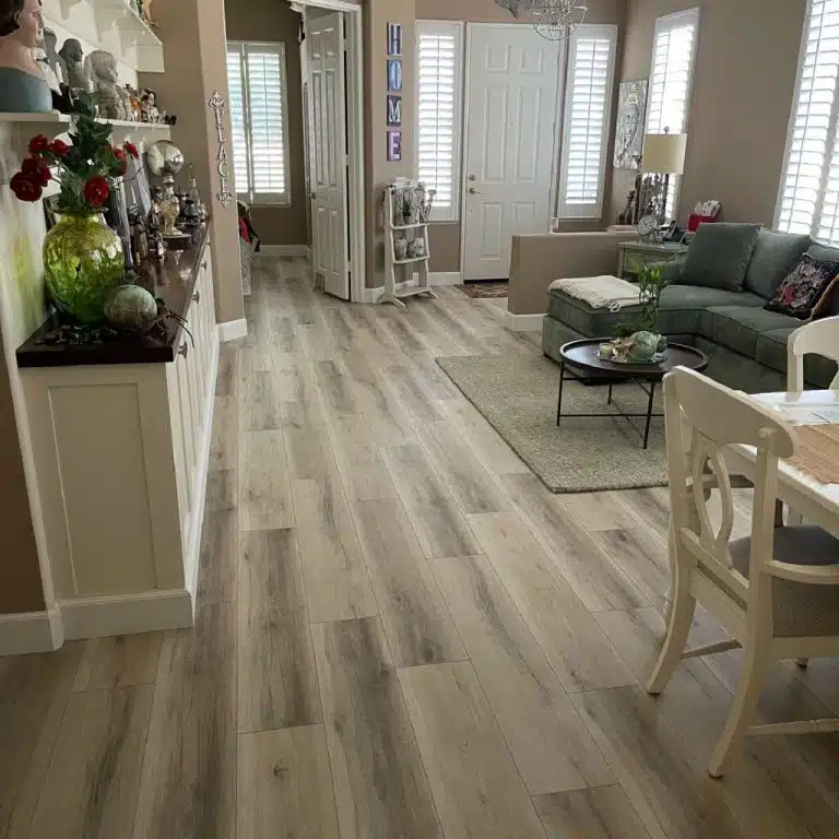 A light-colored hardwood floor in a residential living room restored and refinished by ReCoat Revolution.