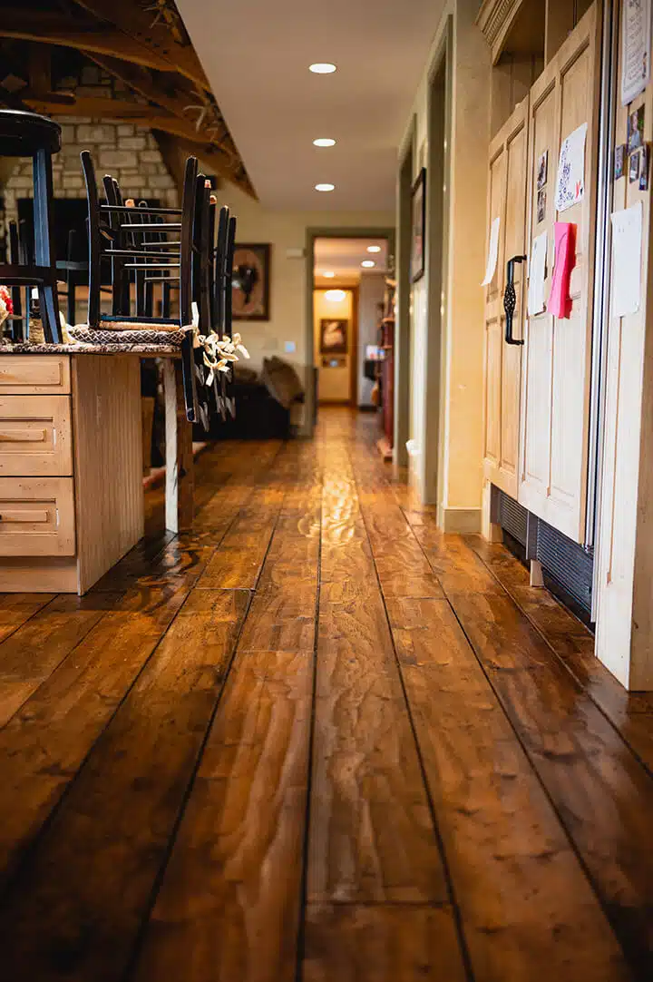 A look into the kitchen area of the Sansone residence with hand-scraped pine plants, carefully restored by ReCoat Revolution.