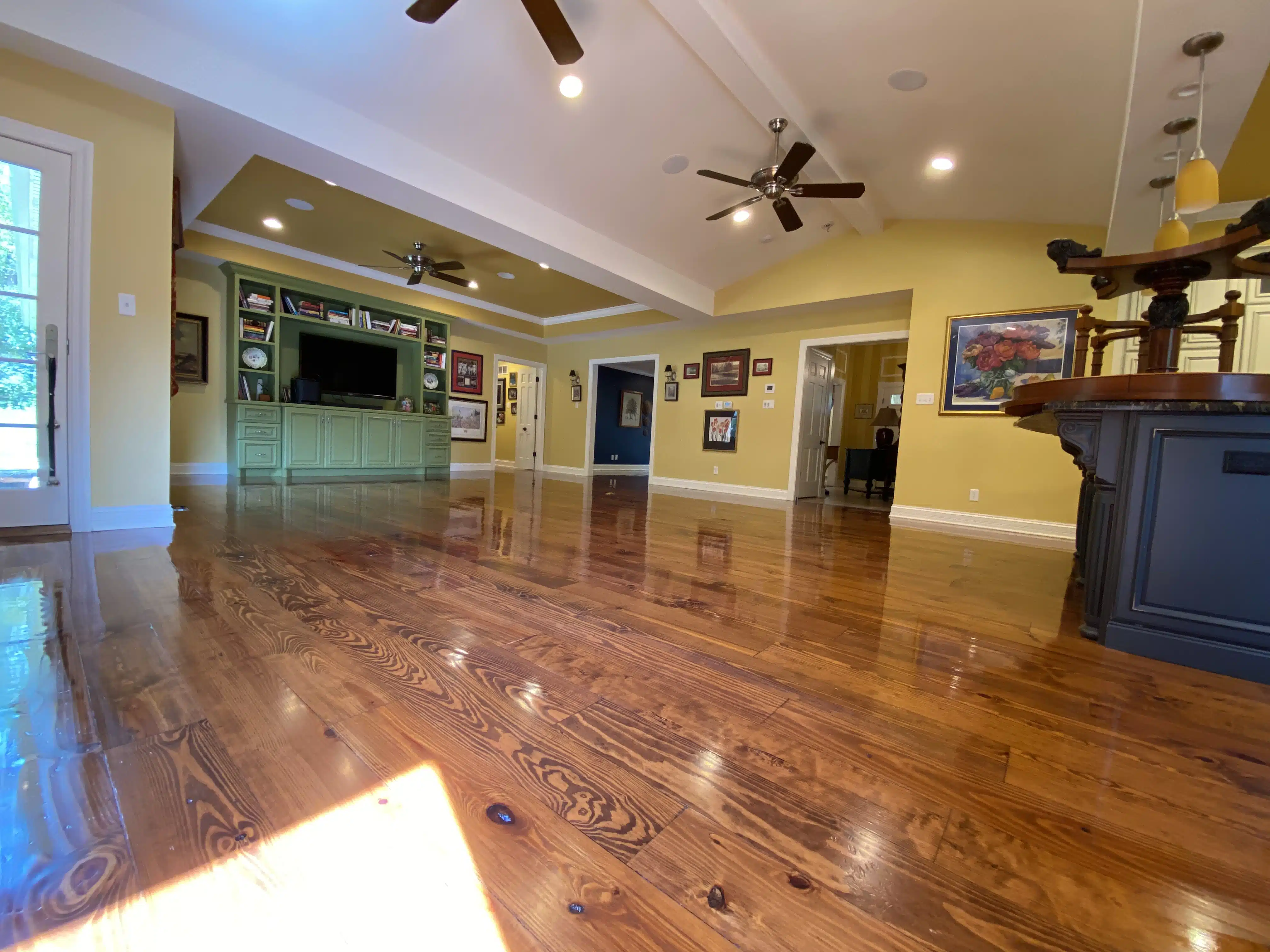A view of the completed, refinished hardwood floor by ReCoat Revolution in a residential living space.