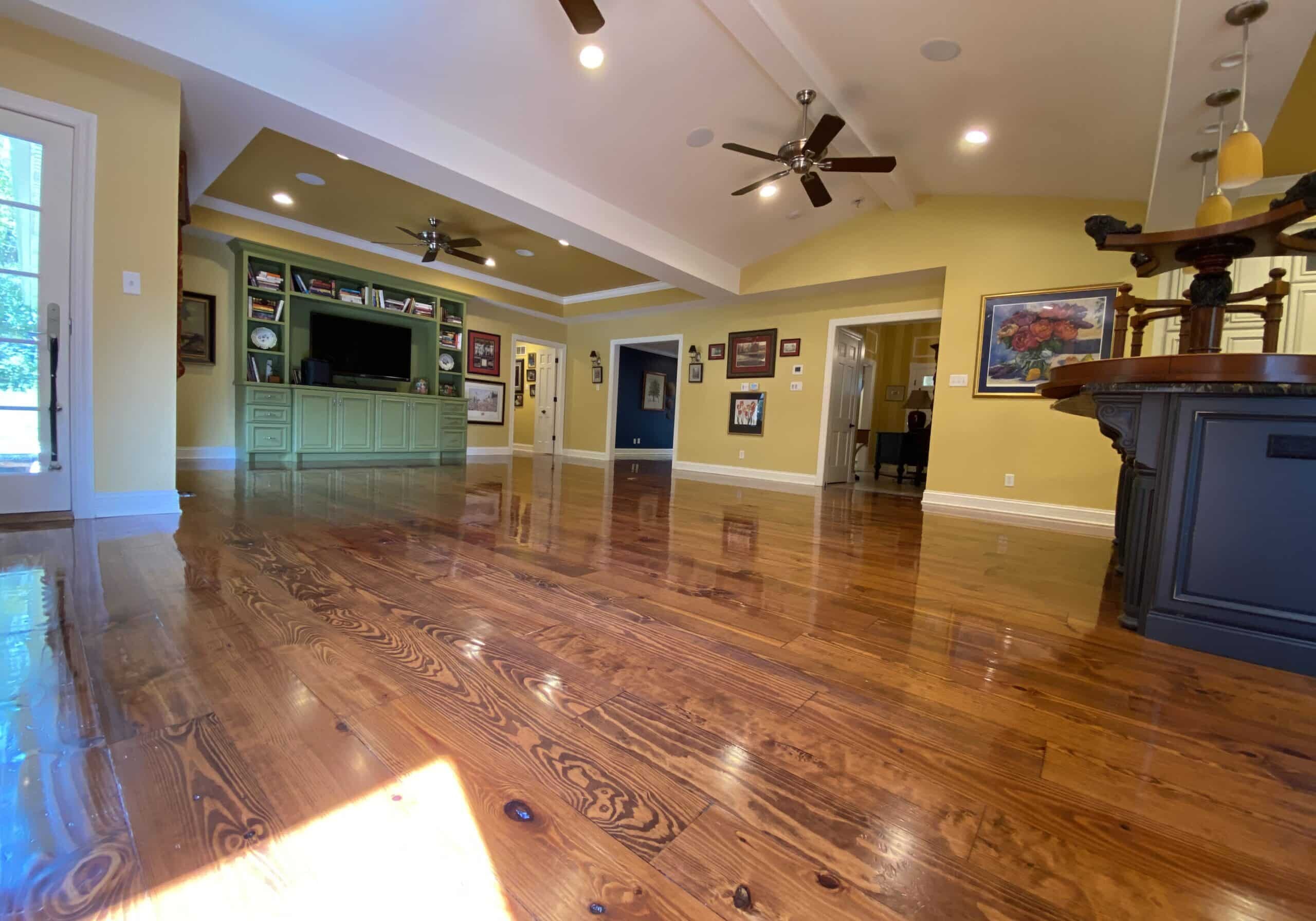 A view of the completed, refinished hardwood floor by ReCoat Revolution in a residential living space.