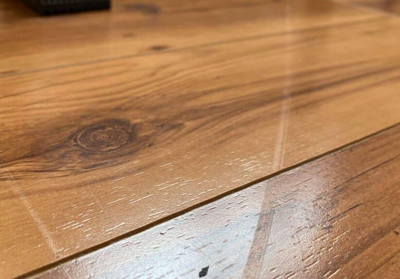 A close-up showing a shallow drag mark on a wooden floor, which can be fixed by ReCoat Revolution.